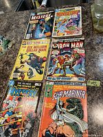 Photo of all six vintage comic books showing cover art and condition.