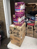 Stack of Depends Silhouette Maximum Absorbency briefs boxes showing packaging and lot quantity.