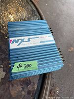 Top view of blue metal amplifier unit with label showing brand Audio Art, model NA-2070X, and 140 watts power rating.