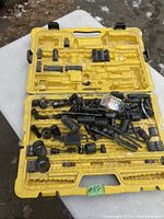 Yellow Stanley branded case open with assorted black sockets, socket extensions, and adapters inside.