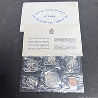 Photo showing Royal Canadian Mint envelope, bilingual informational leaflet, and sealed original plastic packaging with six 1972 Canadian coins in uncirculated condition.