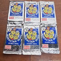 Front view of six sealed packs of Berenstain Bears Storycards, each pack numbered 1 through 6 from the 1992 series, showing colorful foil pack design with cartoon character artwork and information about free inserts.