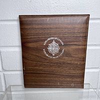 Closed wooden style display case featuring a compass rose logo and 'Explorers of Canada' text in white on the front.