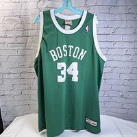 Front view of green Paul Pierce Boston Celtics #34 jersey showing design details including white lettering and NBA logo patch.