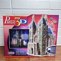 Box of the Puzz-3D Lighted Church Puzzle showing packaging with image of completed lit church and 327 piece count.