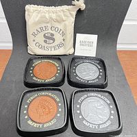 Four Rare Coin Coasters displayed together showing copper and silver coin designs with Pyron Corporation Safety Award text.