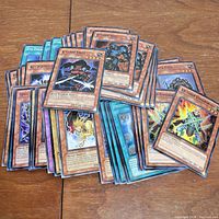 Top view of spread Yu-Gi-Oh trading cards showing multiple monster and spell cards with visible artwork and text