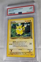 Close-up photo of the 1999 Pokémon Jungle Pikachu card graded Mint 9 by PSA, showing the front of the card including the artwork and text details.