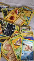 Top view of mixed Pokemon cards showing many species and Trainer card Pokeball