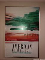 Front view of framed poster showing abstract green and red brushstrokes with text for the 1987 American Film Market event in Los Angeles.