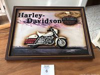 Frontal photo of the framed Harley Davidson wood relief wall art showing the motorcycle, text, eagle and shield logo.
