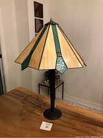 Full view of the stained glass table lamp showing the multi-colored shade and metal base.