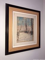 Framed vintage watercolour painting showing winter landscape with trees and snow covered ground, signed Jackie Rosati lower right.