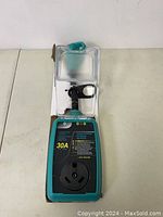 Front view of the 30A surge protector with clear cover and outlet socket showing model labeling and wiring condition indicators.