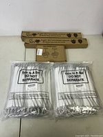 Clear plastic plant watering stakes in sealed packs labeled 'This Is A Set DO NOT SEPARATE'