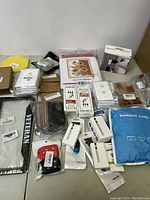 Wide view of various small boxed and packaged items including electronic accessories, personal care items, and household goods.
