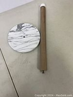 Full view of marble base and wooden post showing design and connection screw