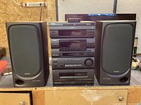 Front view of Aiwa NSX-350M stereo system showing stacked 3 CD player, dual cassette decks, AM/FM tuner, amplifier, and two Aiwa SX-N350 speakers