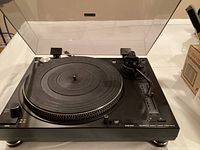 Top view of DJ-1800SQ turntable showing platter, tonearm, control knobs and clear dust cover.