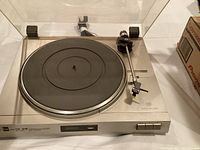 Front angle of Dual CS 515 turntable showing platter, tonearm, and operational buttons.