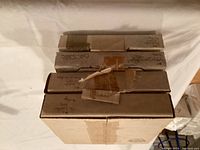 Stack of four original boxes containing Edwin Knowles plates with visible labels handwritten on boxes.