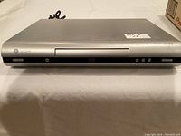 Front view of the GE DVD and CD player showing the disc tray and control buttons