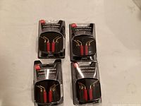 Four unopened packs of Monster Cable Twist Crimp self crimping speaker connectors, each pack containing 8 connectors with red and black grips visible through clear packaging.