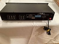 Rear view of the Nikko EQ 25 showing RCA inputs and outputs, power cord, model information and caution labels.