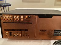 Rear panel showing various video and audio output ports including composite video, S-video, component video, audio outputs, digital optical and coaxial outputs, and IR IN.