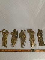 Photo showing all five brass immortals side by side for size reference against a ruler measuring about 15 inches, confirming size range 7-8 inches tall and 3-4 inches wide each.