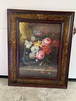 Full view of framed floral painting showing multicolored peonies in dark wooden frame with gold decorative detailing.