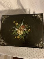 Top view of the lap desk showing hand-painted floral design and mother of pearl inlay in corners