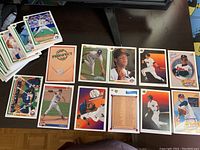 Front display of several random 1991 Upper Deck baseball cards laid out showing various players pitching, batting, and fielding action poses, as well as a Top Prospect checklist card.