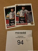 Photo showing front side of two Ed Belfour Upper Deck rookie hockey cards with Chicago Blackhawks uniform.
