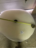 Top view showing measuring tape across the bubble wrap roll confirming width measurement of 35 inches approximately.