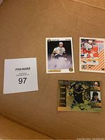 Three Jaromir Jagr hockey cards on cardboard background with MaxSold lot number 97 sign