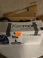 Original Kenmore Elegance Canister Vacuum box showing branding and model information, taped closed.