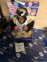 Full frontal view of the Macho Gorilla vintage toy seated in its original box, showing the toy's face, upper body, and packaging details.