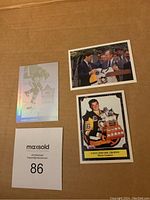Three Mario Lemieux hockey cards displayed on cardboard: a holographic player action card, a card with Lemieux holding Conn Smythe Trophy, and a card showing a formal award presentation.
