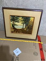 Full view of framed oil painting showing entire artwork and frame with measuring tape for scale.