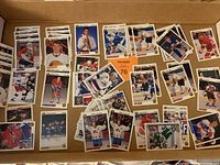Box of assorted hockey rookie and other cards laid out to show player images and card variety including team logos and player portraits.