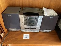 Full view of the Sony stereo system with two speakers side by side on wooden surface.
