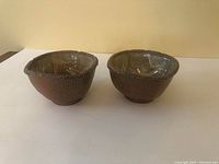 Two ceramic soup bowls displayed side by side, showing bowl shape and exterior texture.