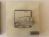 Ceramic wall plaque signed Perce with relief sculpted scene of birds, boat and rocky shore on light ceramic base, plaque detached needing regluing