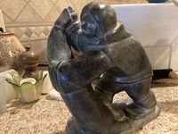 Front-left three-quarter view of Inuit figure wrestling a seal on countertop