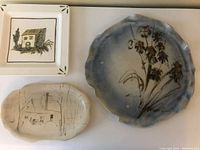 Top view of all three signed ceramic platters showing various shapes and painted designs.