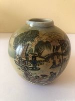 Round Satsuma ware vase featuring hand-painted Japanese scene with figures and natural elements in earthy tones.