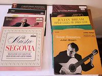 Top view of album covers showing artists Andres Segovia, Julian Bream, Christopher Parkening and album titles in clear view.