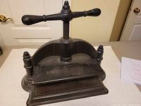 Front view of cast iron book binding press showing overall structure and condition