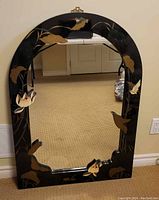 Full view of the lacquered wood mirror showing overall design, frame, and decorative motifs.